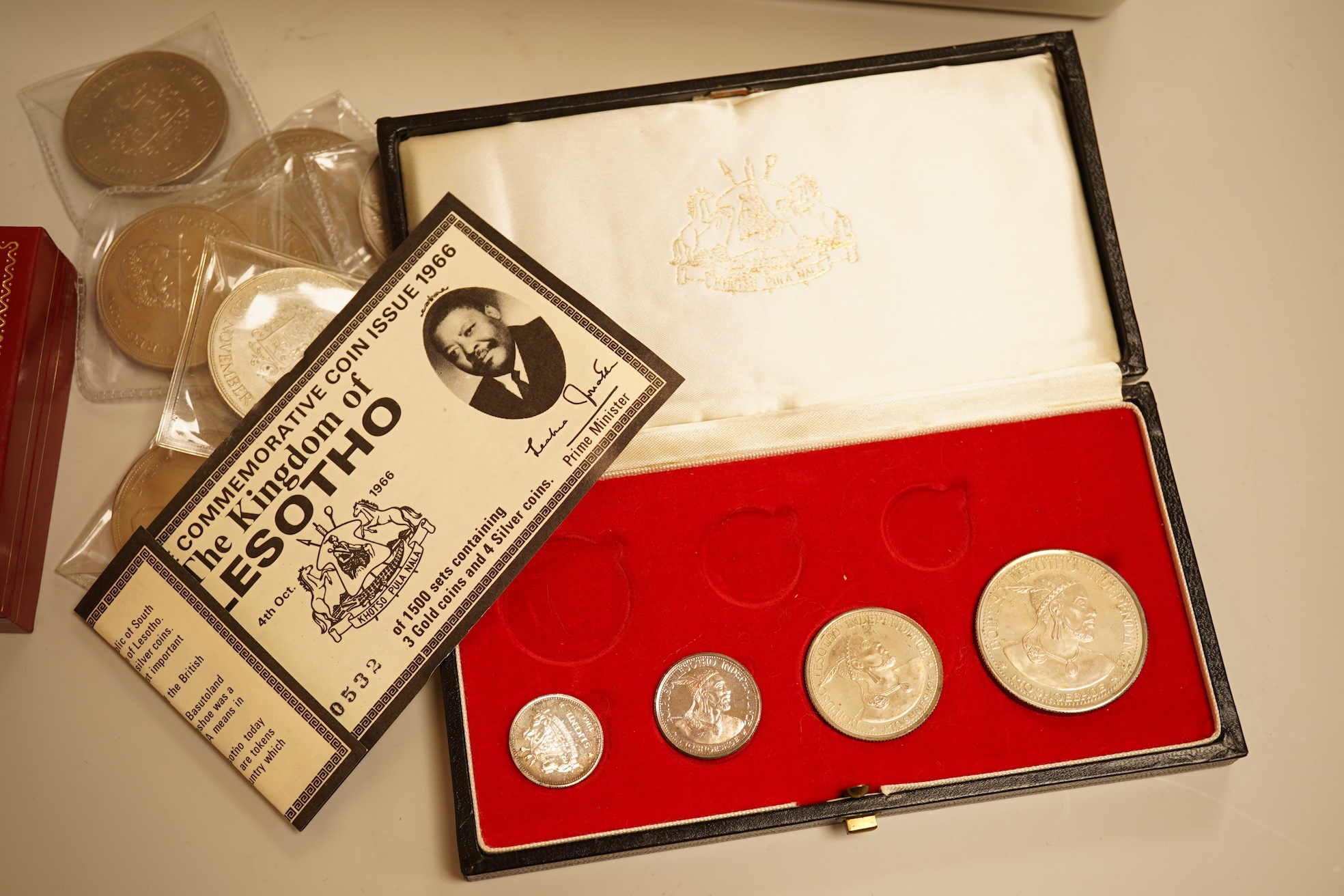 A collection of coins, notes and wrist watches